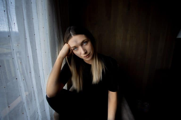 A woman sat on a chair pensively