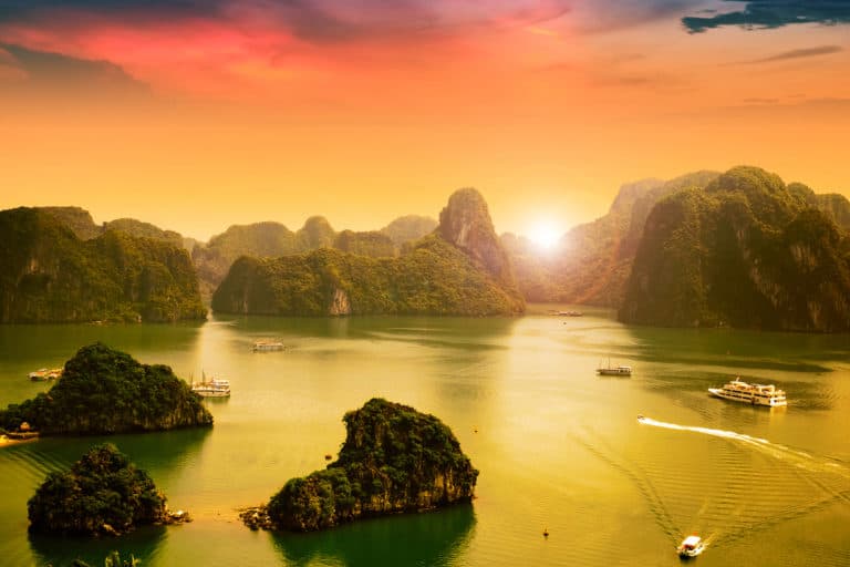 Sun setting over the mountains in Ha Long Bay