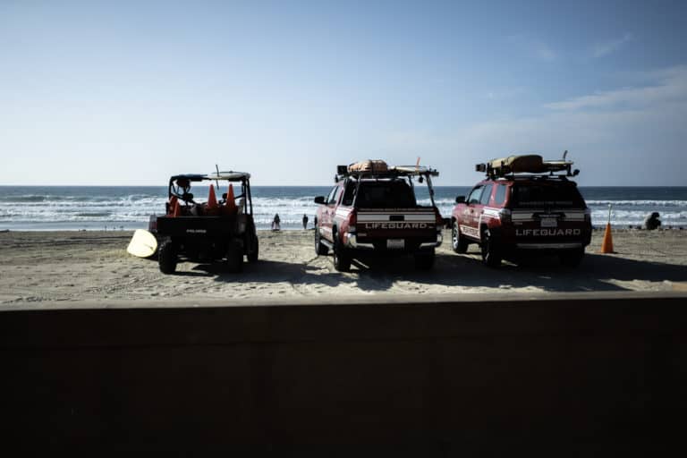 Three lifeguard vehicles on the sand in Mission Beach in San Diego California USA
