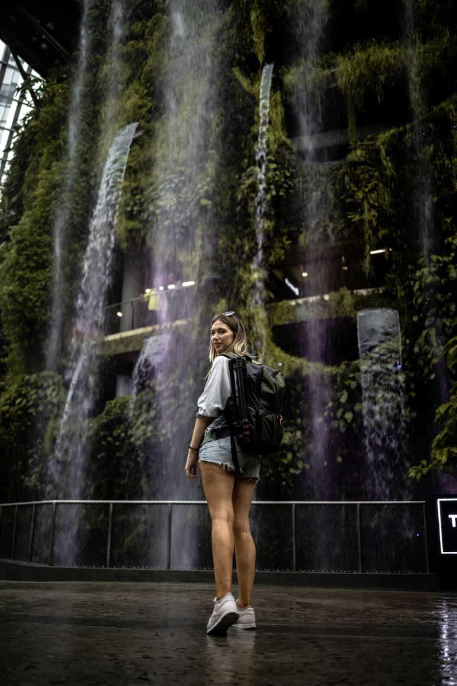 Jodie standing in front of a waterfall at Gardens By The Bay Singapore