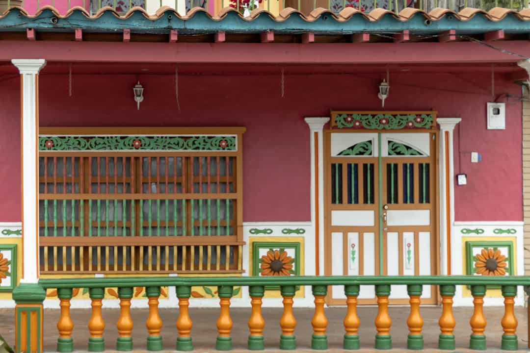31 Must-know Colombia travel tips: Essential things to know before going to Colombia 4 A pink house with rainbow balcony in Guatapé Colombia