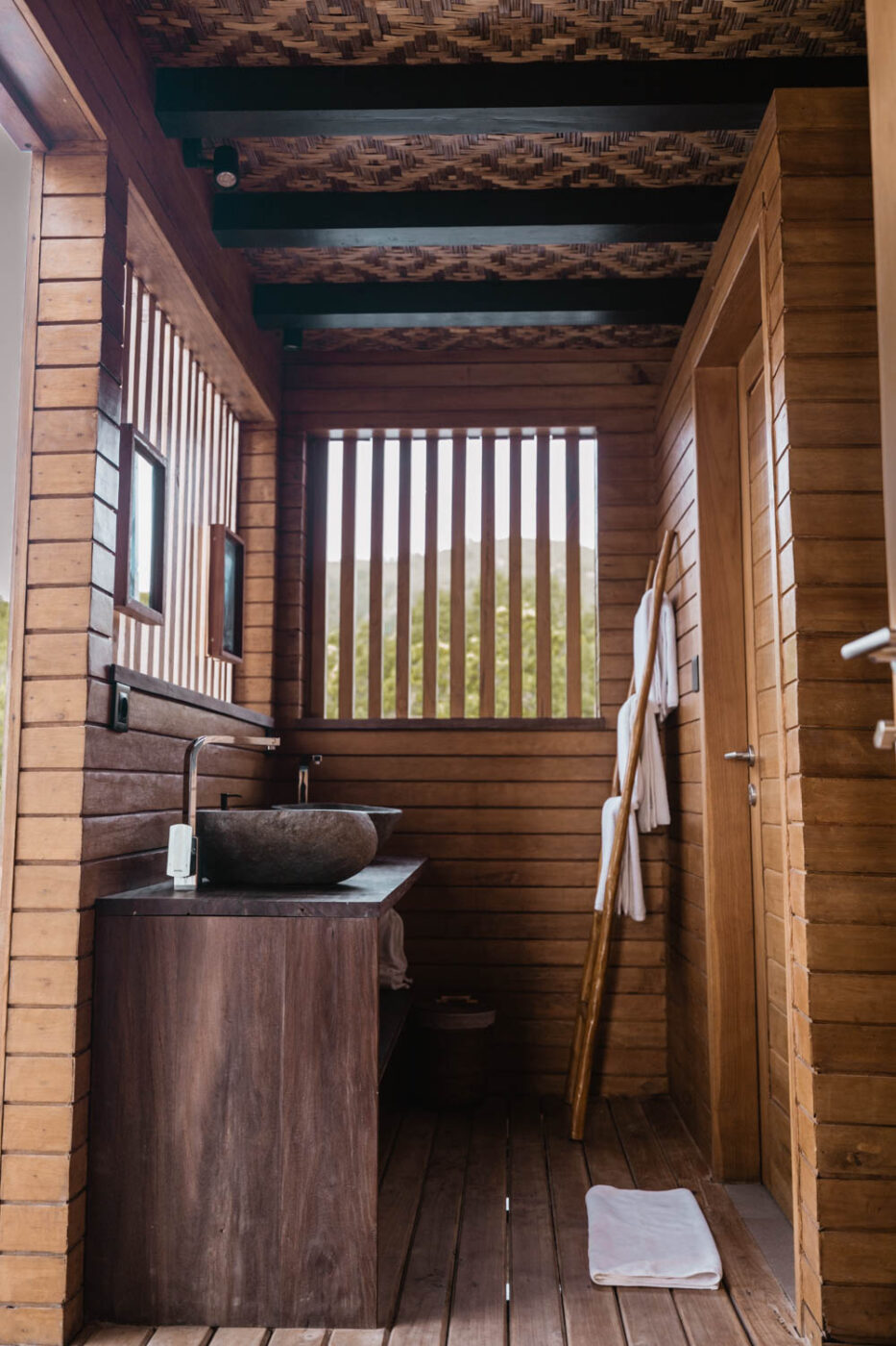 Outdoor bathroom in a sea suite at Menjaga Bay