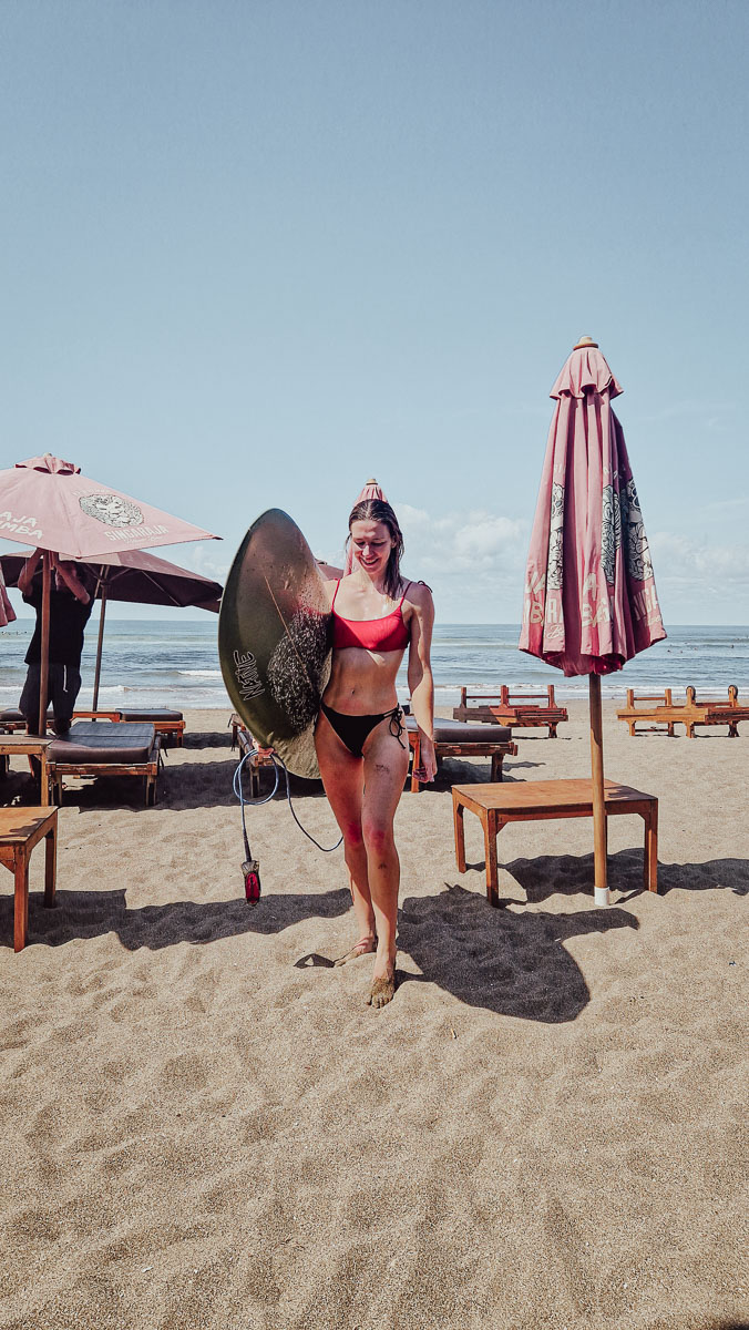 Surfing in Canggu, Bali: A surfer's guide to the best Canggu surf spots (& local tips) 4 Jodie holding a surfboard after surfing in Canggu