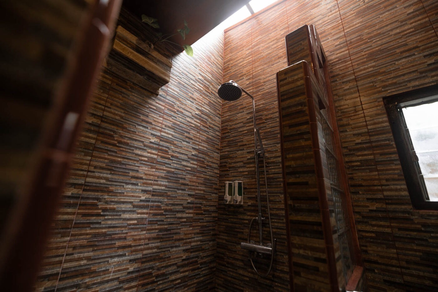A Unique Stay At Tabo Cottages, Samosir Island: A Lake Toba hotel with a story 6 Brick-walled shower in a Deluxe room at Tabo Cottages