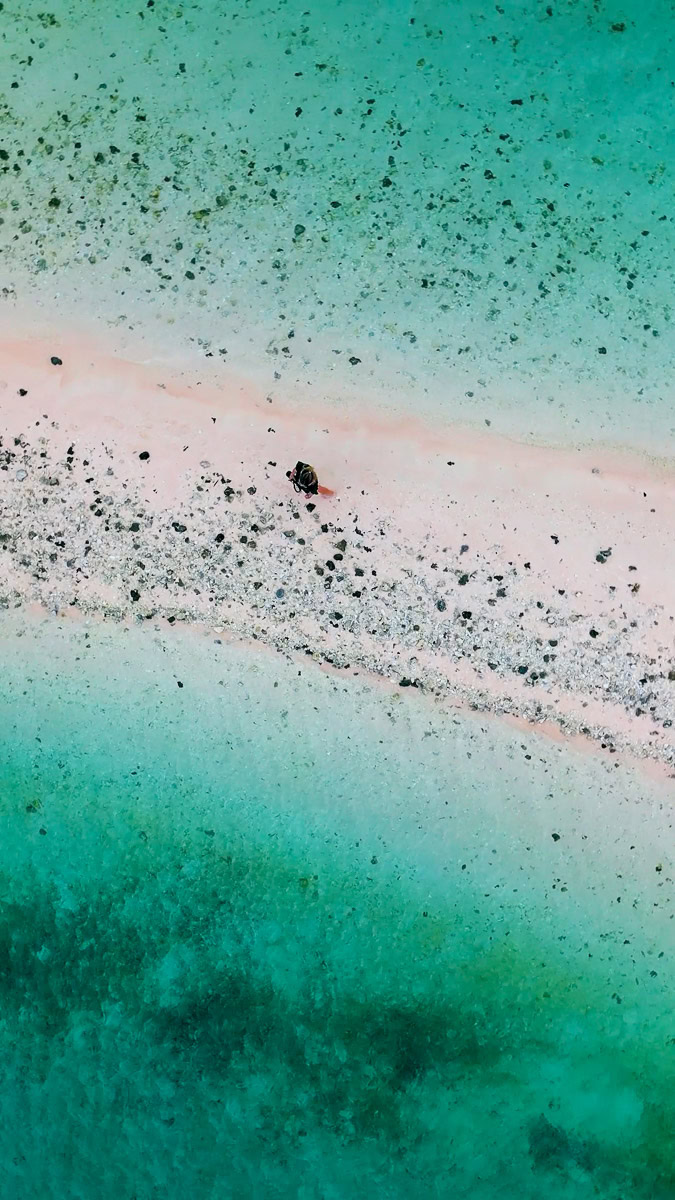 Planning A Komodo Island Day Trip: Tips & Warnings For Booking A Boat Tour Of Komodo Island, Indonesia 8 Aerial shot looking down with Jodie walking alone on Taka Makassar Sand Bar in Komodo National Park