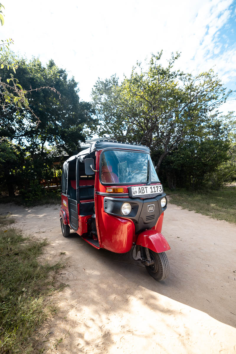 Renting A Tuk Tuk In Sri Lanka: My Experience & Must-Know Tips For Planning Your Tuk Tuk Trip 2 The front of a red tuk tuk with Tuk Tuk Rental branding on it
