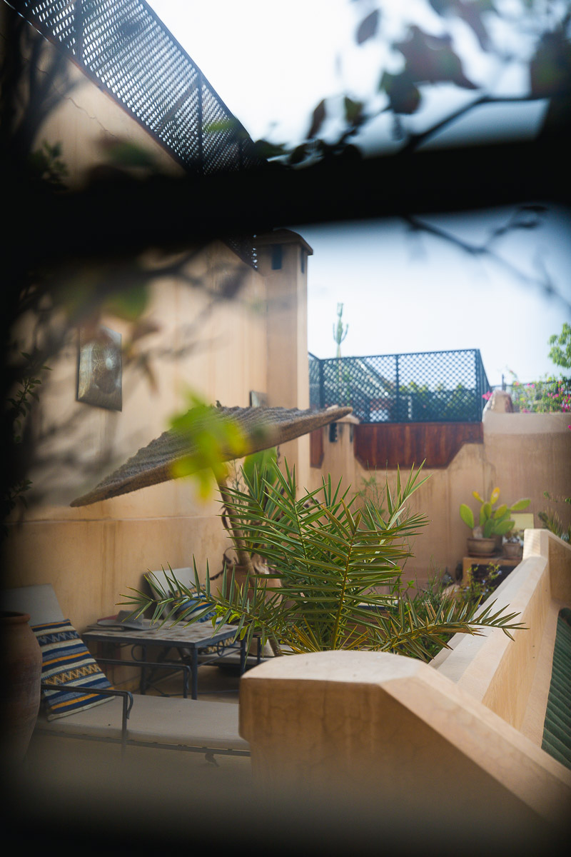 Riad Bamileke (Medina Marrakech): Complete Review & FREE Morocco Travel Guide 4 Looking through a window onto a riad rooftop