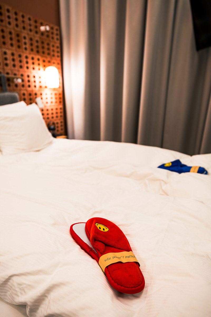 Hobo Hotel Helsinki: A Charmingly Quirky Boutique Hotel in Helsinki, Finland 6 Red slippers on a bed at Hobo Hotel Helsinki Finland